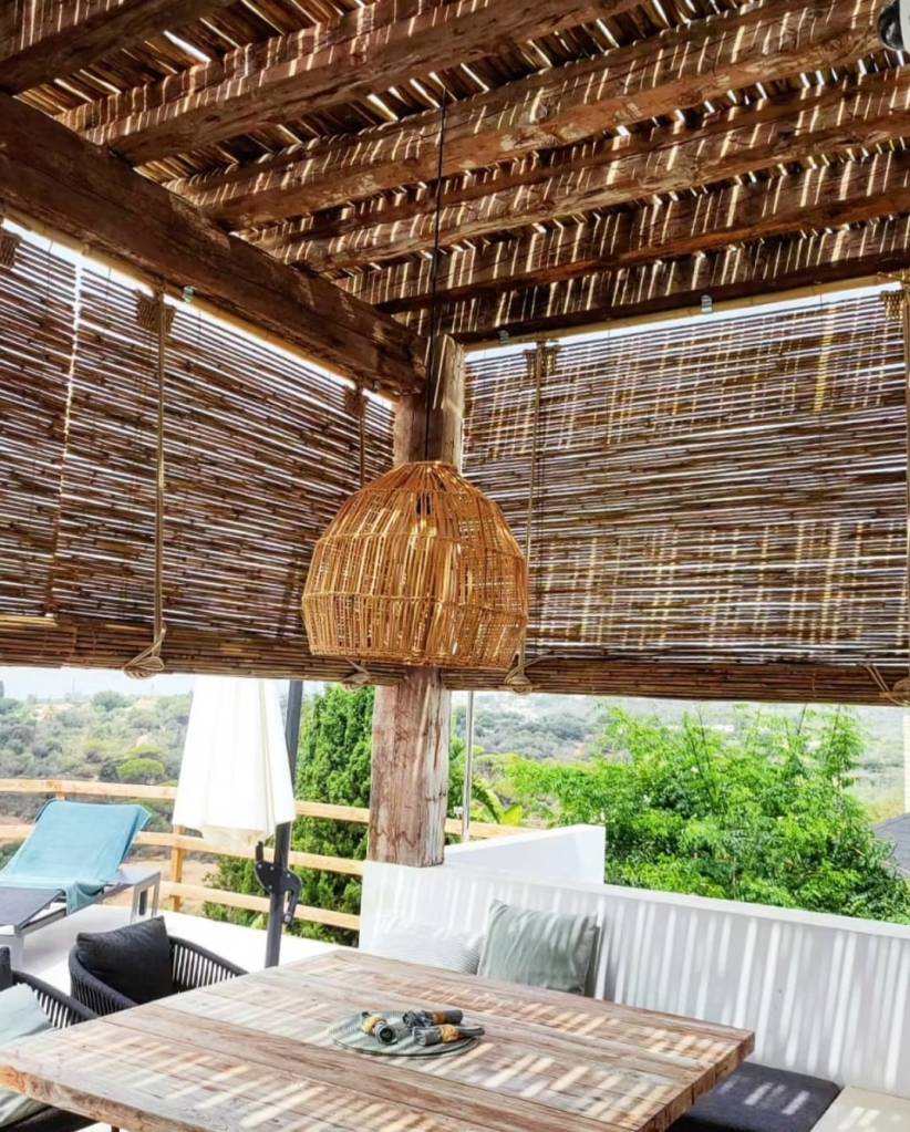 Patio setting including La Julietta by Koko bamboo, manual bamboo roller blinds made in Malaga